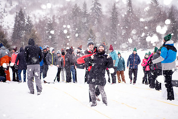 Image showing group of young people having a running in bag competition