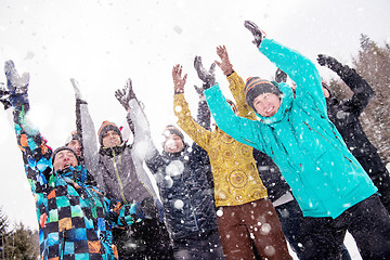 Image showing group of young people throwing snow in the air