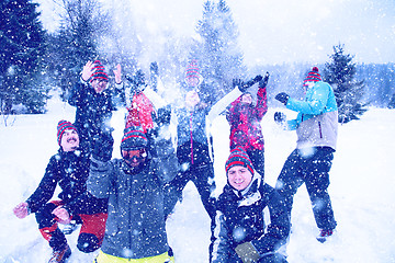 Image showing group of young people throwing snow in the air