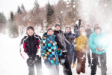 Image showing group of young people throwing snow in the air