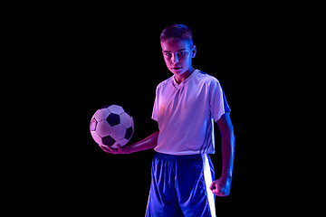 Image showing Young boy as a soccer or football player on dark studio background