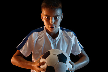 Image showing Young boy as a soccer or football player on dark studio background