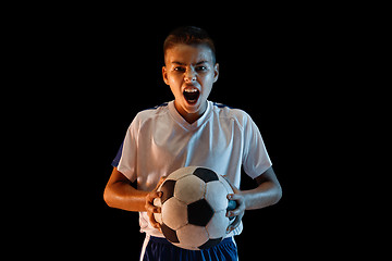 Image showing Young boy as a soccer or football player on dark studio background