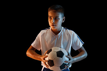 Image showing Young boy as a soccer or football player on dark studio background