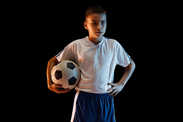 Image showing Young boy as a soccer or football player on dark studio background