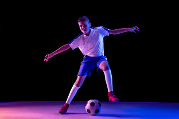 Image showing Young boy as a soccer or football player on dark studio background