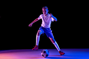 Image showing Young boy as a soccer or football player on dark studio background