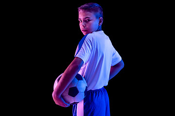 Image showing Young boy as a soccer or football player on dark studio background