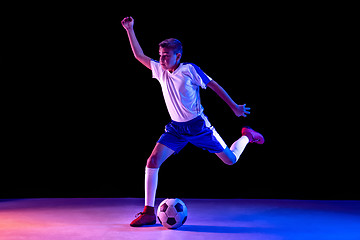 Image showing Young boy as a soccer or football player on dark studio background