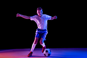 Image showing Young boy as a soccer or football player on dark studio background