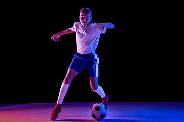 Image showing Young boy as a soccer or football player on dark studio background