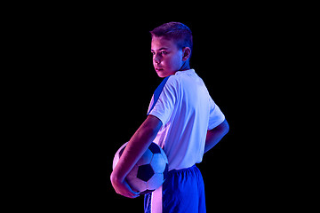 Image showing Young boy as a soccer or football player on dark studio background