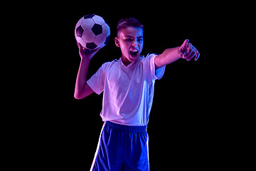 Image showing Young boy as a soccer or football player on dark studio background