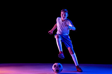 Image showing Young boy as a soccer or football player on dark studio background