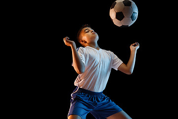 Image showing Young boy as a soccer or football player on dark studio background