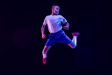 Image showing Young boy as a soccer or football player on dark studio background