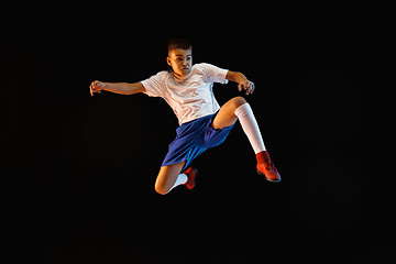 Image showing Young boy as a soccer or football player on dark studio background