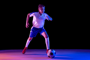 Image showing Young boy as a soccer or football player on dark studio background