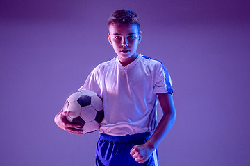 Image showing Young boy as a soccer or football player on dark studio background