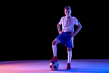 Image showing Young boy as a soccer or football player on dark studio background