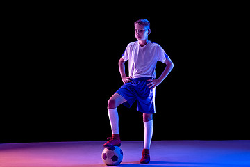 Image showing Young boy as a soccer or football player on dark studio background