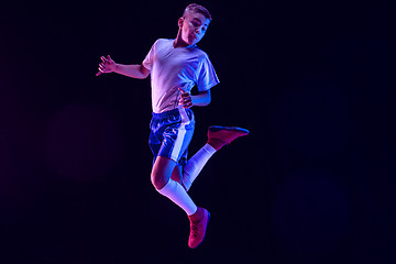 Image showing Young boy as a soccer or football player on dark studio background