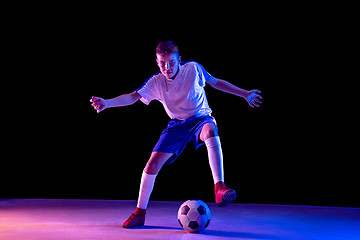 Image showing Young boy as a soccer or football player on dark studio background