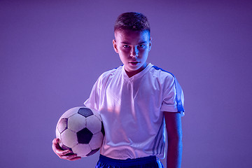 Image showing Young boy as a soccer or football player on dark studio background