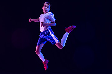 Image showing Young boy as a soccer or football player on dark studio background