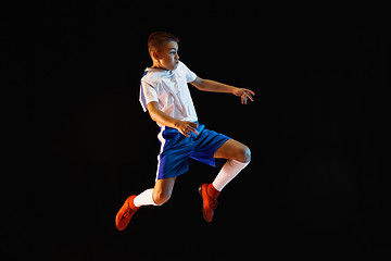 Image showing Young boy as a soccer or football player on dark studio background