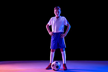 Image showing Young boy as a soccer or football player on dark studio background