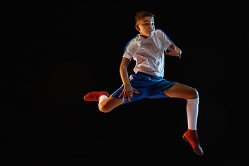 Image showing Young boy as a soccer or football player on dark studio background