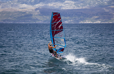 Image showing Young windsurfer in the waves in the sea