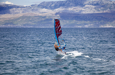 Image showing Young windsurfer in the waves in the sea