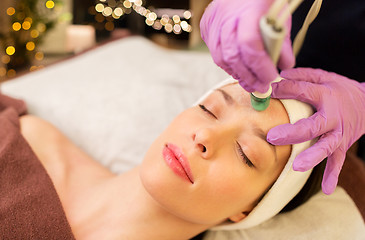 Image showing woman having microdermabrasion facial treatment