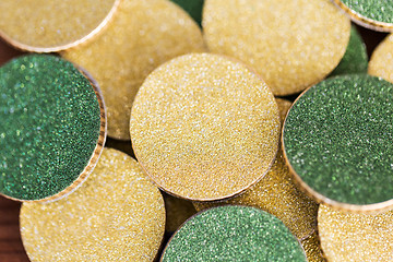 Image showing close up of golden and green coins