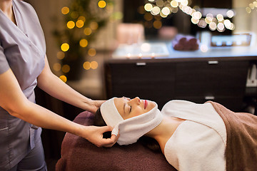 Image showing woman having face massage with towel at spa parlor