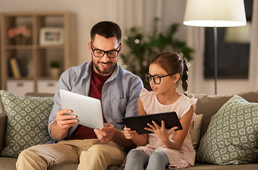 Image showing father and daughter with tablet computers at home