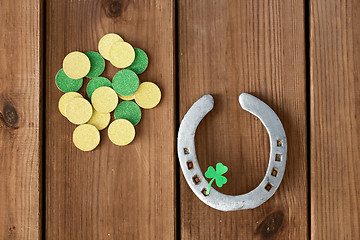 Image showing horseshoe with shamrock on wooden background