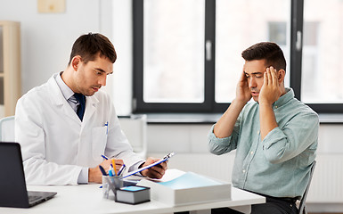 Image showing doctor and male patient having headache at clinic