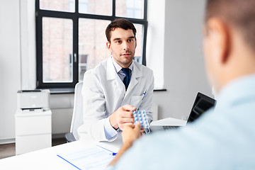 Image showing doctor giving medicine to male patient at hospital