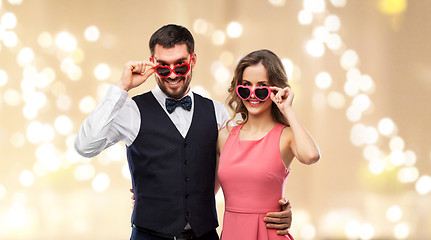 Image showing happy couple in heart-shaped sunglasses