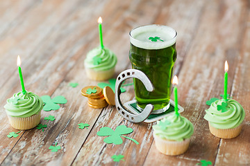 Image showing glass of beer, cupcakes, horseshoe and gold coins