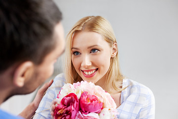 Image showing happy couple with flowers at home