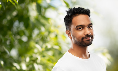 Image showing smiling young indian man over gray background