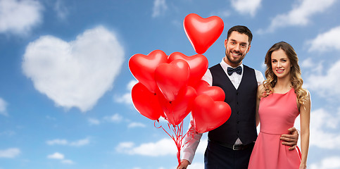 Image showing happy couple with red heart shaped balloons