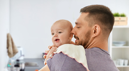 Image showing father with baby over kitchen background