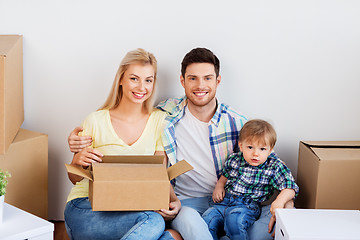 Image showing happy family with boxes moving to new home