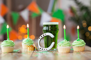 Image showing glass of beer, cupcakes, horseshoe and gold coins