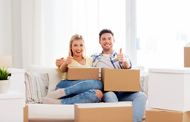 Image showing happy couple with boxes moving to new home